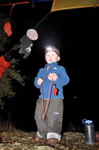 2-year-old Sam uses of his personal headlamp around camp. Photo: Rick Shone