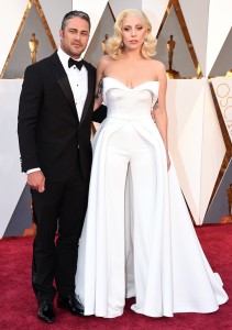 Taylor Kinney, left, and Lady Gaga arrive at the Oscars on Sunday, Feb. 28, 2016, at the Dolby Theatre in Los Angeles. (Photo by Jordan Strauss/Invision/AP)