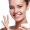 girl-applying-moisturizer-to-face-smiling