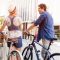 Happy young couple in city with bike