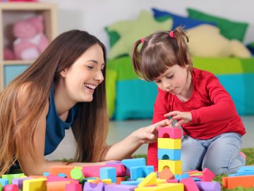 Mother and daughter playing with construction toys
