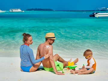 family-with-three-year-old-boy-on-beach-9SEARFB