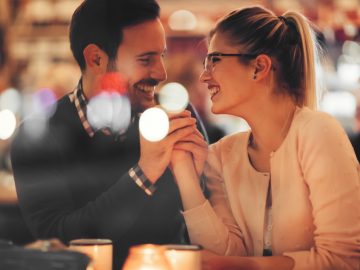 Romantic couple dating at night in pub