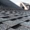 selective focus of grey shingles on rooftop of building